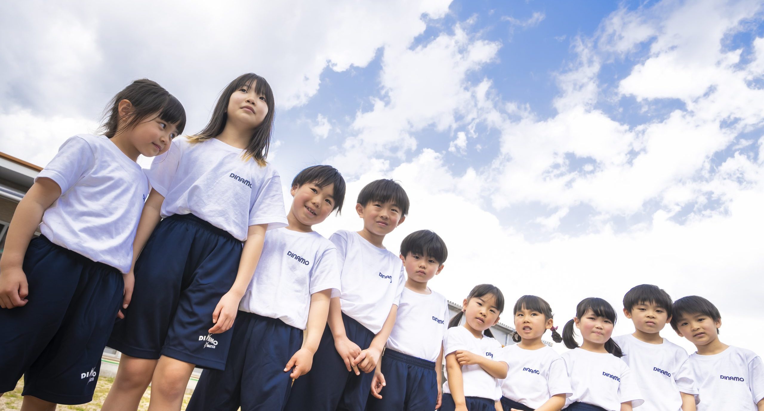 空の下に並ぶディナモ体操クラブの子どもたち